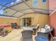 Comfortable covered patio with lounge chairs, hot tub, and outdoor seating area at 3010 Secret Lake Dr, Kissimmee, FL 34747