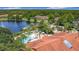 Aerial view showcasing community pool, palm trees, gazebo, and lake at 3010 Secret Lake Dr, Kissimmee, FL 34747
