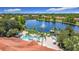 Aerial view of pool and lake featuring a fountain, umbrellas, and manicured green space at 3010 Secret Lake Dr, Kissimmee, FL 34747
