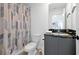 Modern bathroom features a stylish vanity and granite countertop, plus a decorative shower curtain at 3308 Tranquil Trl, Kissimmee, FL 34747