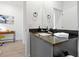 Updated bathroom featuring a large mirror, granite counters, and ample lighting at 3308 Tranquil Trl, Kissimmee, FL 34747