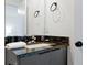 Bathroom vanity featuring dark granite countertops and modern sink fixtures at 3308 Tranquil Trl, Kissimmee, FL 34747