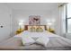 Bright bedroom with wooden headboard, yellow nightstands, vibrant pillows, and modern artwork at 3308 Tranquil Trl, Kissimmee, FL 34747