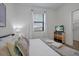 Bright bedroom with white walls, a large window, and a TV on a dresser at 3308 Tranquil Trl, Kissimmee, FL 34747