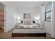 Simple bedroom featuring bed, white nightstands and window with blinds at 3308 Tranquil Trl, Kissimmee, FL 34747