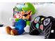 Close-up of Mario Bros plushy and controller pillow on bed in themed bedroom at 3308 Tranquil Trl, Kissimmee, FL 34747