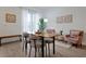 Well-lit dining room featuring modern table and chairs with light wood flooring at 3308 Tranquil Trl, Kissimmee, FL 34747