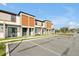 Modern townhome exteriors featuring a large parking area and inviting outdoor seating at 3308 Tranquil Trl, Kissimmee, FL 34747