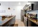 Modern kitchen with granite countertops, black cabinets, and stainless steel appliances at 3308 Tranquil Trl, Kissimmee, FL 34747