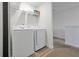 Bright laundry room with side-by-side washer and dryer, plus storage shelves at 3308 Tranquil Trl, Kissimmee, FL 34747