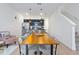 Open concept living/dining area with kitchen access and modern staircase at 3308 Tranquil Trl, Kissimmee, FL 34747