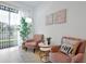 Bright living room with comfy pink chairs and a decorative area rug at 3308 Tranquil Trl, Kissimmee, FL 34747