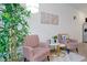 Cozy living room with pink armchairs, stylish decor, and ample natural light at 3308 Tranquil Trl, Kissimmee, FL 34747