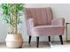 Close-up of a pink armchair beside a decorative green plant at 3308 Tranquil Trl, Kissimmee, FL 34747