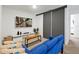Cozy living room with a blue sofa, large TV, and sliding closet doors at 3308 Tranquil Trl, Kissimmee, FL 34747