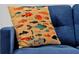 Close-up of a fish-themed decorative pillow on a blue sofa at 3308 Tranquil Trl, Kissimmee, FL 34747