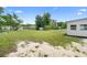 Large, grassy backyard with a shed and the side of a white house with vinyl siding at 36 Morning Glory Dr, Debary, FL 32713