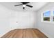 Bedroom with wood-look floors, closet, doors and a window providing lots of natural light at 36 Morning Glory Dr, Debary, FL 32713