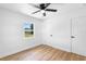Bedroom featuring wood-look floors, white doors, and a window providing natural light at 36 Morning Glory Dr, Debary, FL 32713