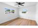 Bedroom featuring wood-look floors, a ceiling fan, and large windows for natural light at 36 Morning Glory Dr, Debary, FL 32713