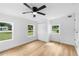 Bedroom with a ceiling fan, wood-look floors, closet, and windows providing lots of light at 36 Morning Glory Dr, Debary, FL 32713