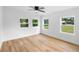 Bright bedroom with wood-look floors, a ceiling fan, and multiple windows offering natural light at 36 Morning Glory Dr, Debary, FL 32713