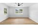 Well-lit bedroom with hardwood floors, neutral paint, and double-paned windows offering natural light at 36 Morning Glory Dr, Debary, FL 32713