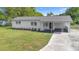 Charming single-story home with a modern white exterior, covered entry, and well-maintained lawn at 36 Morning Glory Dr, Debary, FL 32713