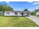 Charming single-story home with a modern white exterior, covered entry, and well-maintained lawn at 36 Morning Glory Dr, Debary, FL 32713