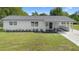 Charming single-story home with a modern white exterior, covered entry, and well-maintained lawn at 36 Morning Glory Dr, Debary, FL 32713