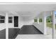 The spacious modern porch features a dark door and smooth concrete flooring at 36 Morning Glory Dr, Debary, FL 32713