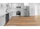 Modern kitchen with stainless steel appliances, quartz countertops, white cabinets, and hardwood flooring at 36 Morning Glory Dr, Debary, FL 32713