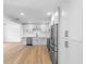 Modern kitchen featuring hardwood floors, white cabinets, stainless steel appliances, and quartz countertops at 36 Morning Glory Dr, Debary, FL 32713