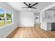 Bright and spacious living room featuring hardwood floors, a ceiling fan, and modern white cabinets at 36 Morning Glory Dr, Debary, FL 32713