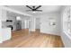 Open floor plan featuring hardwood floors, white trim, lots of light, an open doorway, and stainless steel appliances at 36 Morning Glory Dr, Debary, FL 32713
