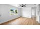 Bright living room featuring hardwood floors, a modern ceiling fan, and a large window offering natural light at 36 Morning Glory Dr, Debary, FL 32713