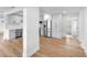 Bright and spacious living space featuring hardwood floors, white trim, lots of light, an open doorway, and stainless appliances at 36 Morning Glory Dr, Debary, FL 32713