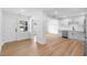 Bright and spacious living space featuring hardwood floors, white trim, lots of light, an open doorway, and modern cabinets at 36 Morning Glory Dr, Debary, FL 32713