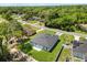 A high-angle aerial view of the home, showing backyard and treelined neighborhood at 4345 Sw 143Rd Lane Rd, Ocala, FL 34473