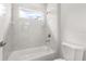 Bathroom featuring tiled walls, a bathtub, and a showerhead at 4345 Sw 143Rd Lane Rd, Ocala, FL 34473