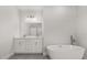 Bathroom boasts a dual sink vanity and a freestanding soaking tub at 4345 Sw 143Rd Lane Rd, Ocala, FL 34473