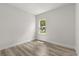 Bright bedroom featuring wood-look flooring and a window offering natural light at 4345 Sw 143Rd Lane Rd, Ocala, FL 34473