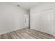 Bedroom showcases wood-look flooring and a glimpse into another room at 4345 Sw 143Rd Lane Rd, Ocala, FL 34473