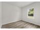 Bright bedroom featuring wood-look flooring and a window offering natural light at 4345 Sw 143Rd Lane Rd, Ocala, FL 34473