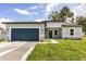 Charming single-story home with a blue garage door, well-kept lawn, and a modern gray exterior at 4345 Sw 143Rd Lane Rd, Ocala, FL 34473