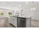 Bright kitchen island with quartz countertop, stainless steel dishwasher, and pendant lighting at 4345 Sw 143Rd Lane Rd, Ocala, FL 34473