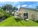 Backyard view featuring a hammock, patio seating, and lush landscaping at 462 Lakepark Trl, Oviedo, FL 32765