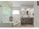 Modern bathroom featuring a glass-enclosed shower and double vanity sinks at 462 Lakepark Trl, Oviedo, FL 32765