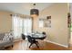 Modern dining area with sleek lighting, tile flooring, and views of the backyard at 462 Lakepark Trl, Oviedo, FL 32765