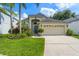 Charming home with lush landscaping, a well-manicured lawn, and a two-car garage at 462 Lakepark Trl, Oviedo, FL 32765